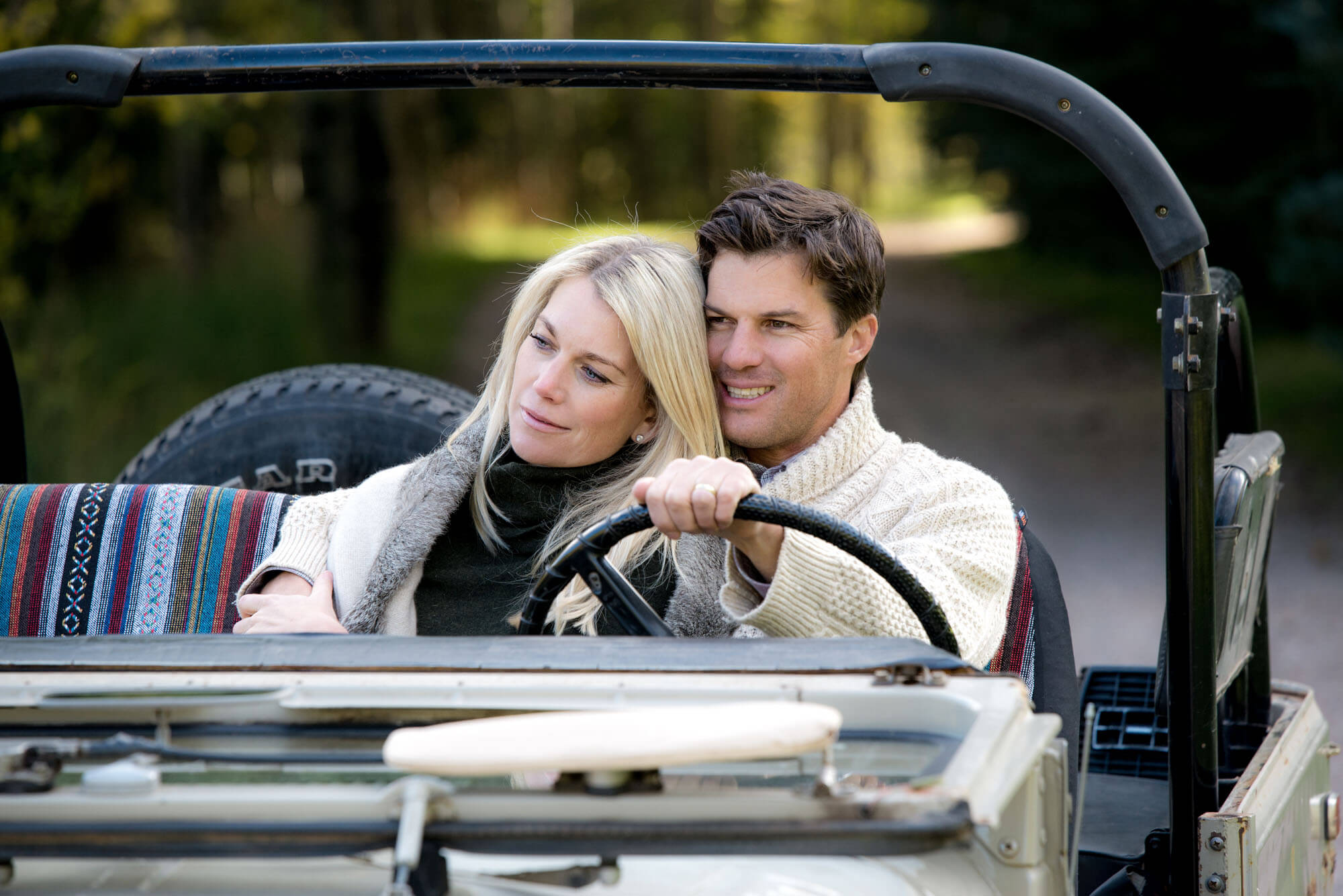 photo of a couple driving in a vintage jeep taken by Aspen photographer Michele Cardamone